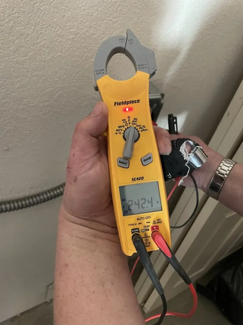 Voltage testing with clamp meter during Recessed Lighting Installation in Putney